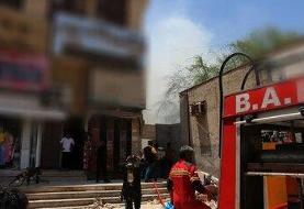 نجات زن گرفتار در آتش‌سوزی منزل مسکونی